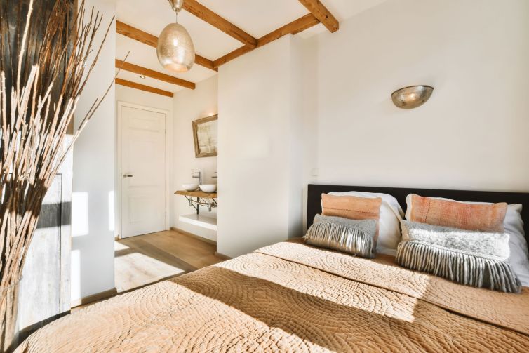 comfortable-bedroom-with-a-beige-plaid-on-the-bed-2025-02-10-11-53-47-utc